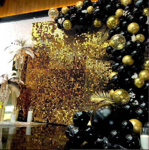 Decorative arch made of black and gold balloons