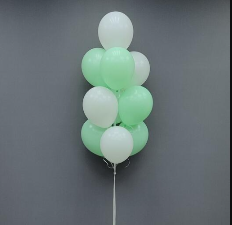 Bunch of pastel green and white latex balloons