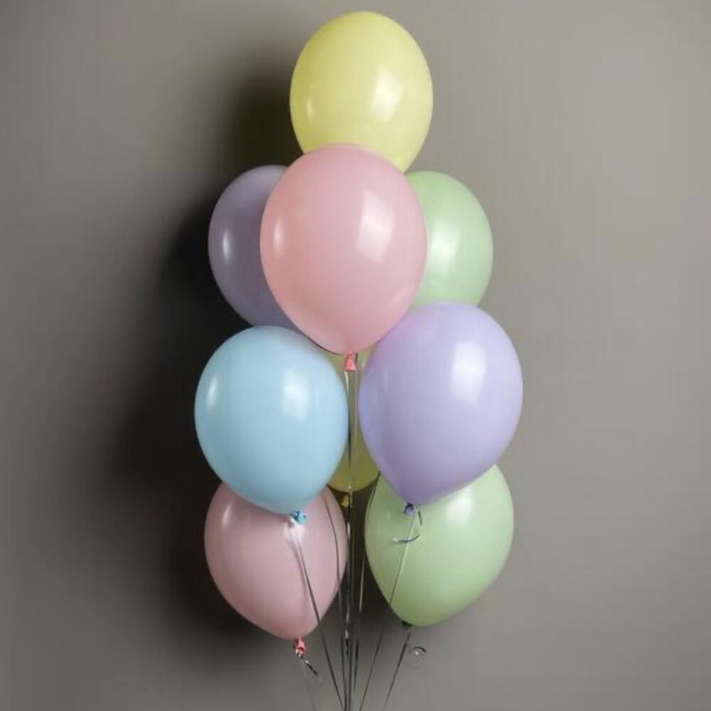 Soft pastel balloon bouquet with light, neutral colors.