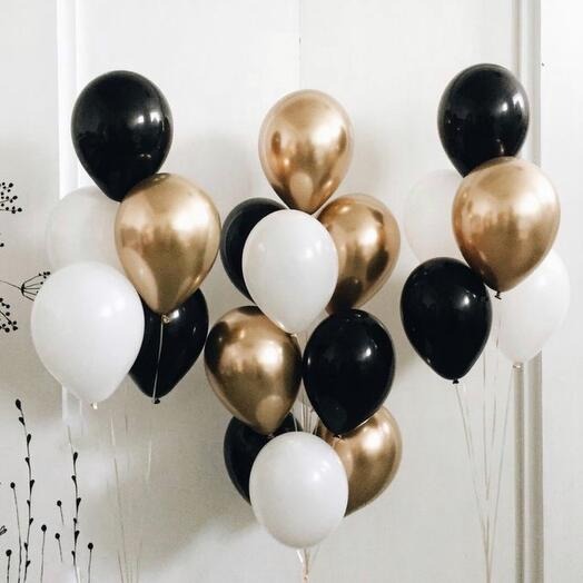 Balloon bouquet with black, gold, and white balloons 