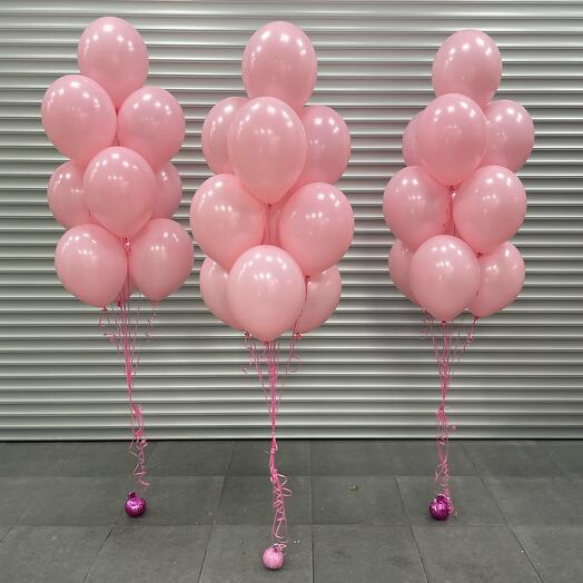 Three bunches of pastel pink latex balloons with ribbons 