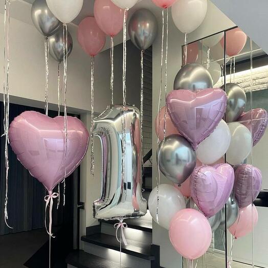 Decorative balloons including heart-shaped and number balloons and latex balloons in bunches with some ceiling balloons