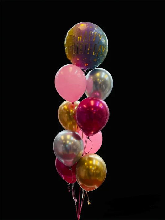 bunch of colourful balloons including a 'Happy Birthday' foil balloon 
