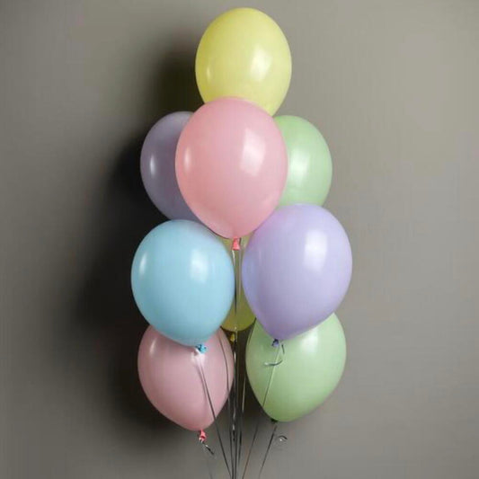 Soft pastel balloon bouquet with light, neutral colors.
