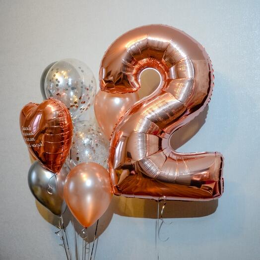 Rose gold number '2' balloon with other balloons in a bouquet